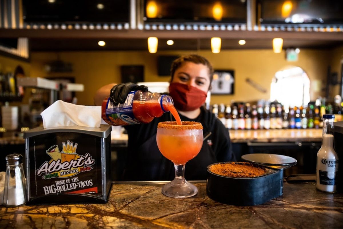 Staff member pouring a drink